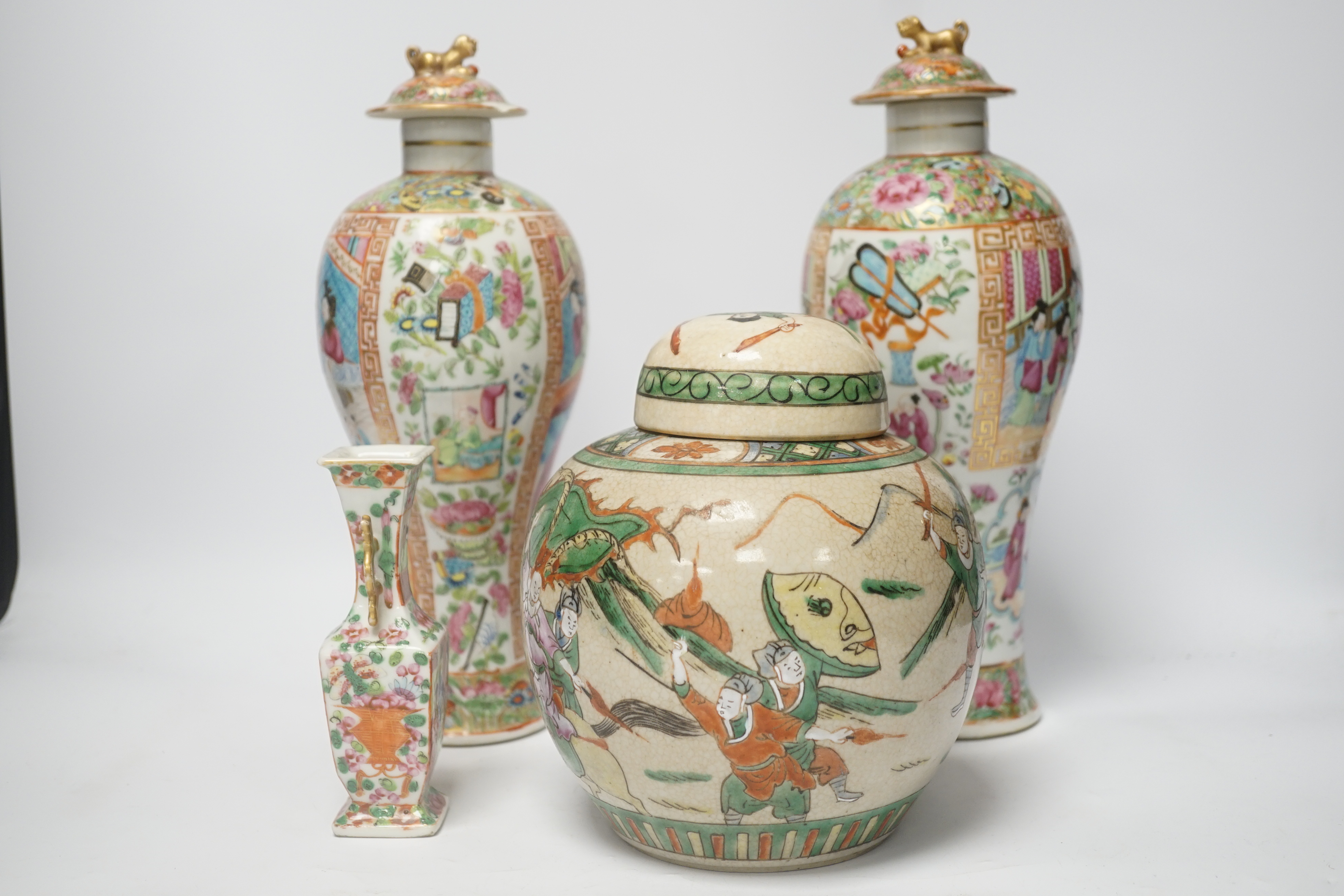 A pair of 19th century Chinese famille rose vases and covers, a similar small vase and a a famille verte crackle glaze jar, tallest 31cm